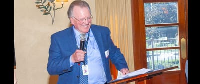 A resident enjoying a speech in a warm interior setting