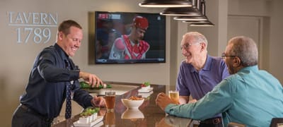 Residents enjoying drinks at a facility bar area