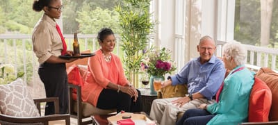Residents enjoying drinks in a bright common area