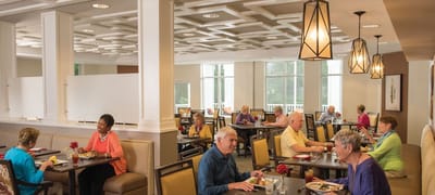 Residents enjoying meals in a dining room setting