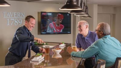 Three men enjoying drinks in a common area
