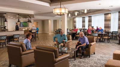 Residents chatting in a comfortable dining area