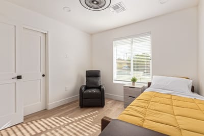 Private resident room with a bed and chair