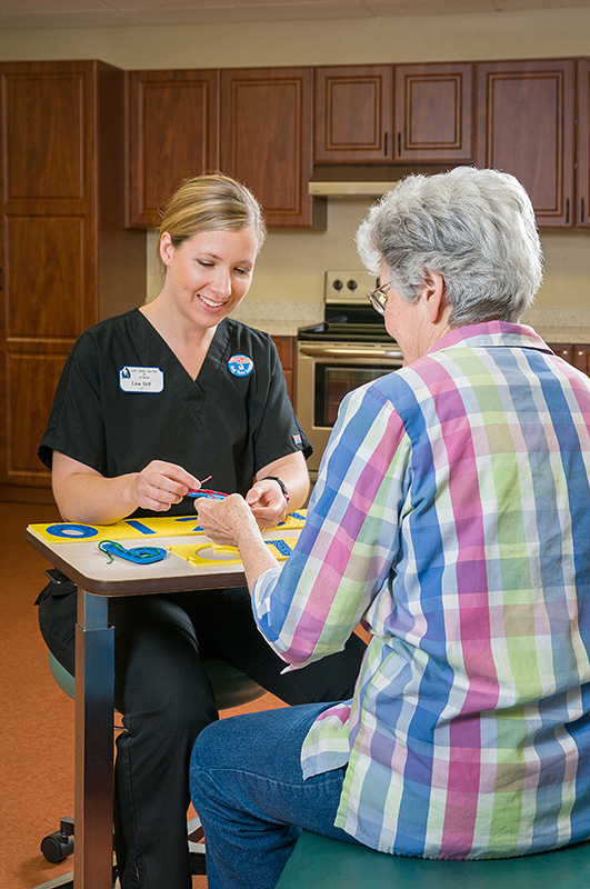 Staff member engaging with a resident in an activity