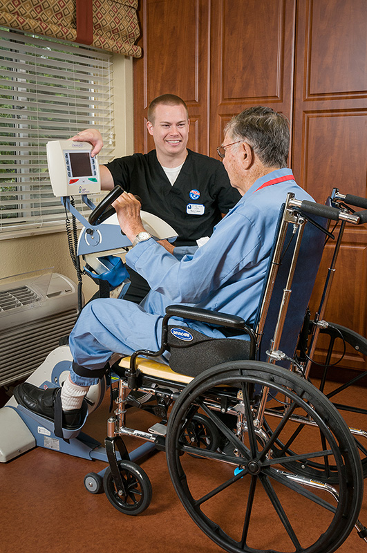Healthcare professional assisting a resident in a wheelchair