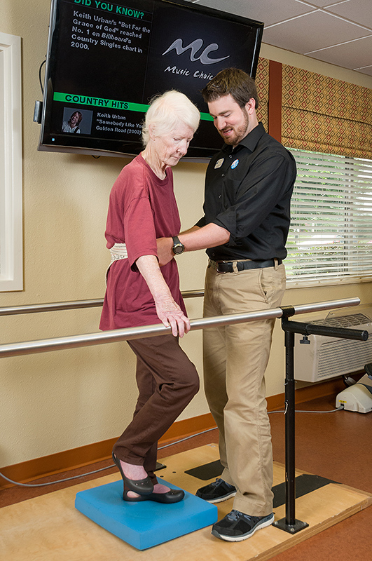 Staff assisting a resident during therapy session