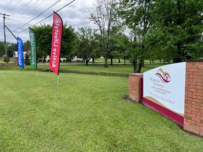 Exterior view of Mountain Memories facility with signage