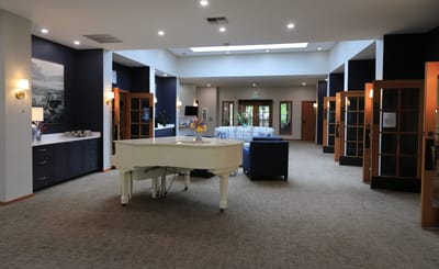 Bright common area with piano and seating