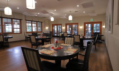 Bright dining room with tables set for a meal