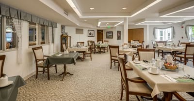 Bright dining room with tables set for a meal