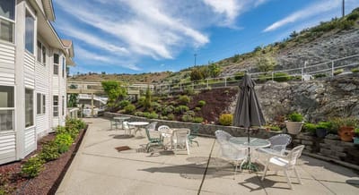 Outdoor patio area with seating and landscaping