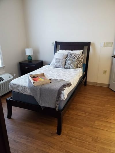 A private resident room with a bed and personal items