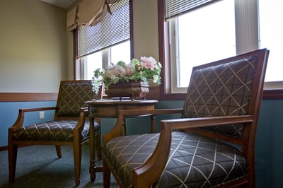 Cozy seating area with floral decor by the windows