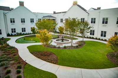 Serene landscaped courtyard with fountain and walking paths