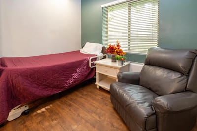 Cozy resident room with bed and chair