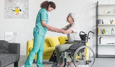 Caregiver assisting a resident in a bright living area