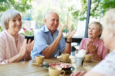 Residents enjoying coffee and dessert while socializing