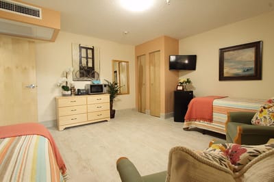 Spacious private resident room with two beds and decor