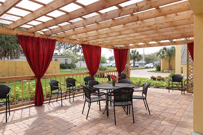 Outdoor seating area with a pergola and garden views