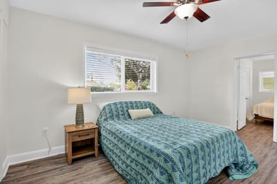 A cozy room with a blue patterned bedspread