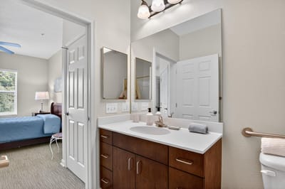 Brightly lit resident room with bathroom
