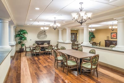 Bright common area with dining tables and chairs