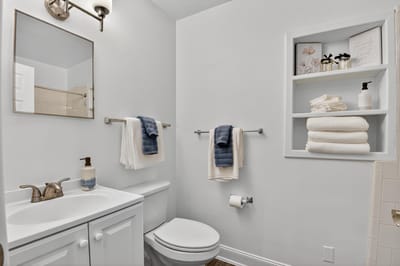 Bright, clean restroom with towels and toiletries