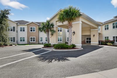 Entrance of Blue Palms Senior Living with landscaping