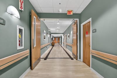 Interior hallway with doors leading to resident rooms