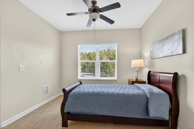 Cozy private resident room with a bed and lamp