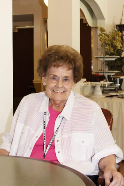 Resident smiling in a cozy common area