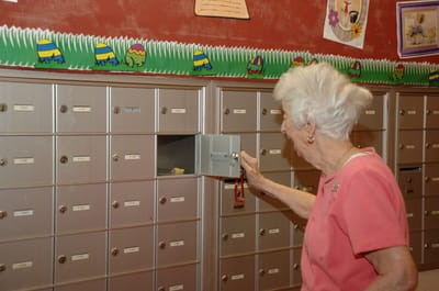 Resident checking mail in a common area of the facility