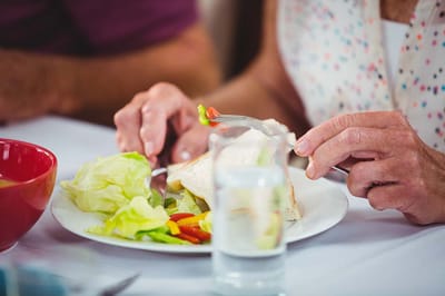 Close-up of a resident enjoying a meal