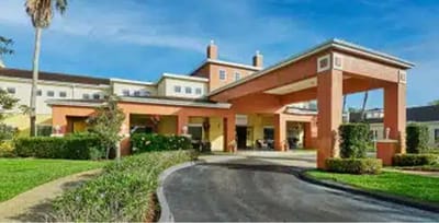 Entrance of a senior living facility with landscaped grounds