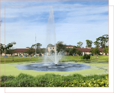 A scenic outdoor view of the facility's pond and fountain