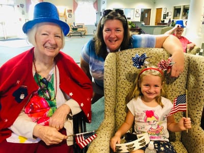Residents and staff celebrating with flags indoors