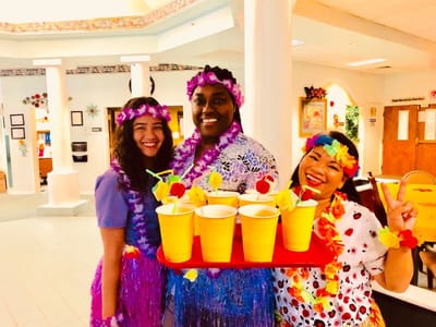 Staff hosting a themed activity with drinks