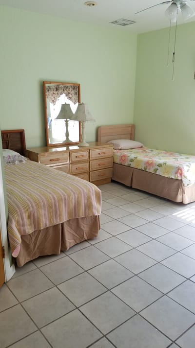 A cozy resident room with two beds and soft decor