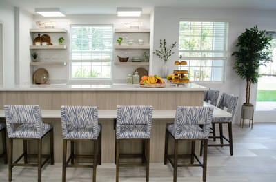 Bright dining area with fruit display and seating