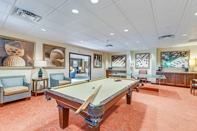 Interior activity room with billiards table and decor