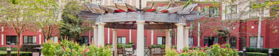 Outdoor gazebo surrounded by colorful flowers