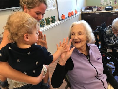 Residents interacting joyfully in an activity room