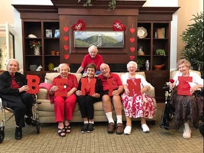 Residents celebrating with letters in a common area