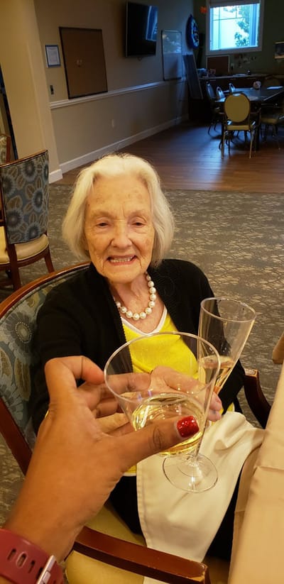 A resident raising a glass in a celebration