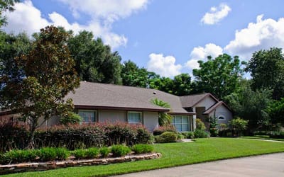 Exterior view of a senior living facility with greenery