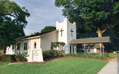 Exterior view of a senior living facility with landscape