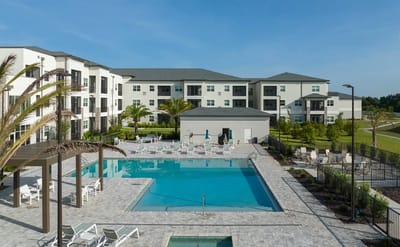 Aerial view of a swimming pool and facility building