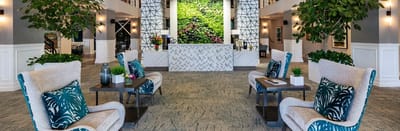 Bright lobby area with comfortable seating and greenery