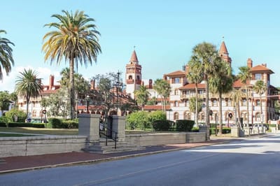 Exterior view of a senior living facility with palm trees