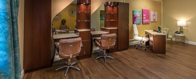 Hair salon area with stylist chairs and mirrors